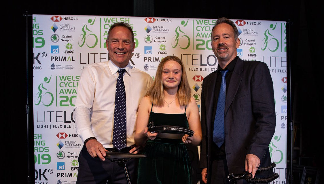 Neil Barron of Litelok (right) and Mike Mellor from Quella (left) awarding Jess with her new bike and lock.